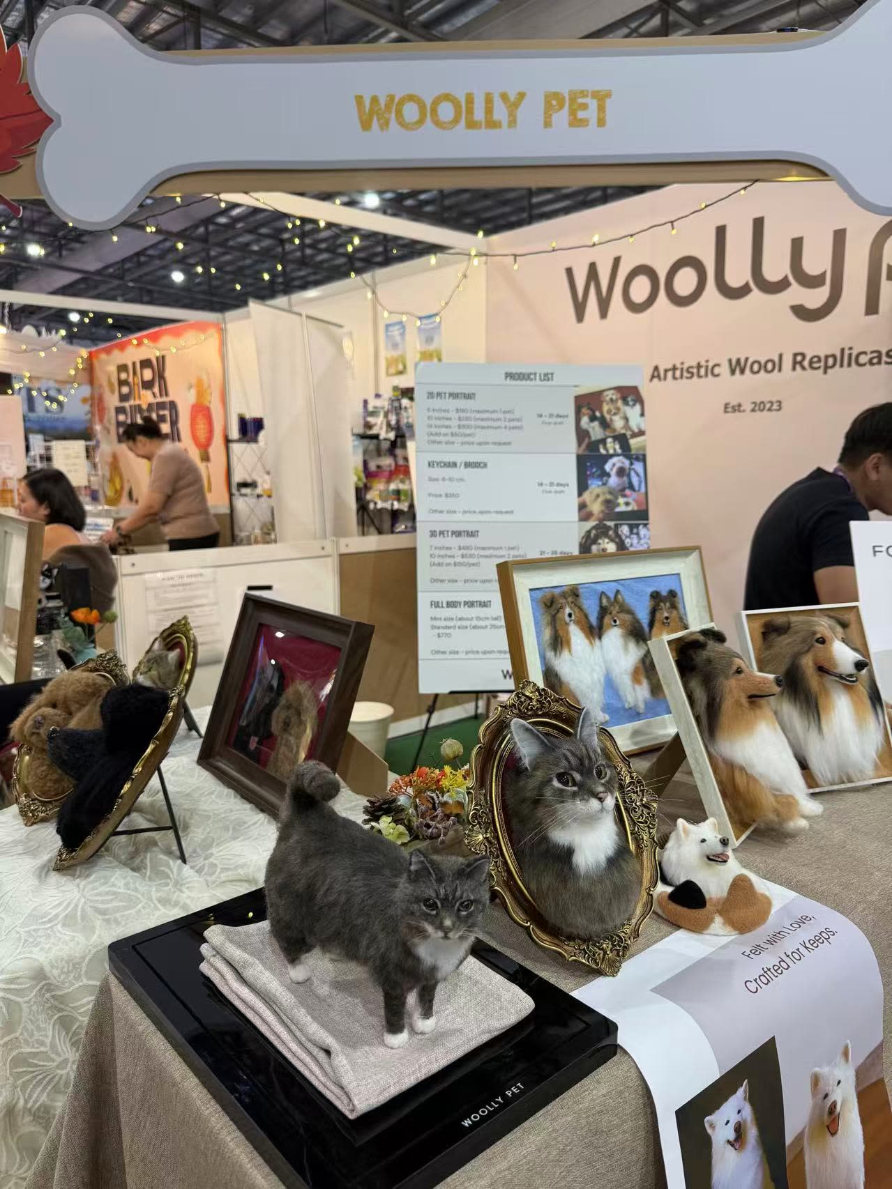 Felted cats and framed portraits on the display table at Pet Expo Fiesta 2025